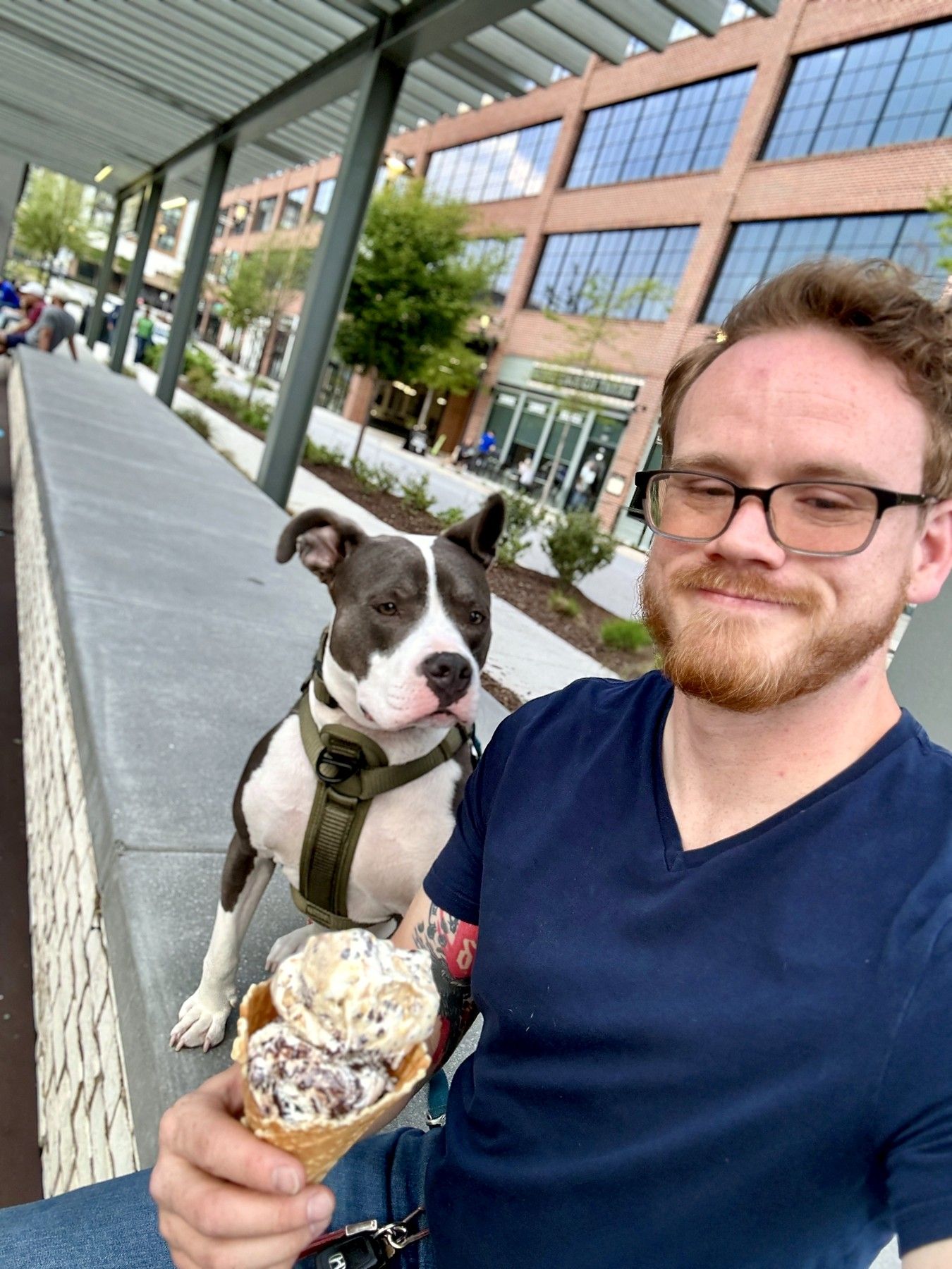 Phillip holding an ice-cream cone with Lucky looking over his shoulder